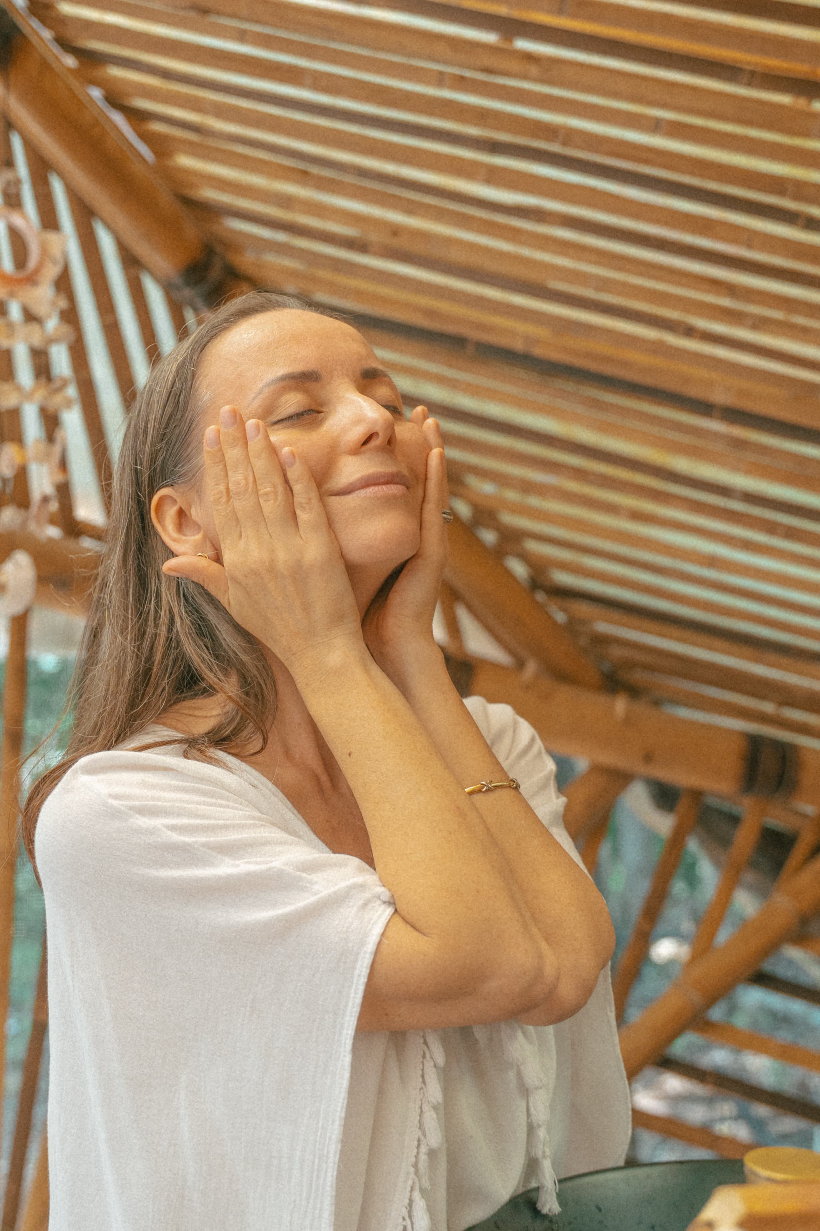Woman resting her hands on her face, calm and relaxed